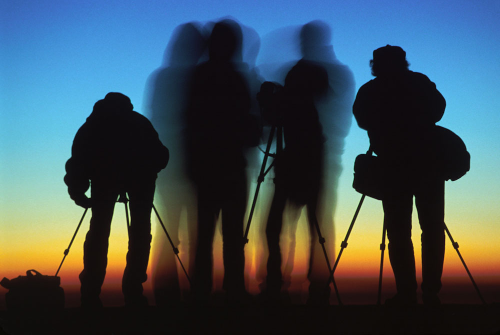 Silhouettes of four photographers at sunrise on Mount Nemrut, Turkey