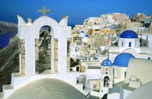 Bell towers and blue-domed Greek Orthodox Churches, Oia, Santorini Island, Greece, Europe