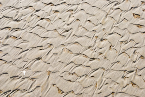 Tides have shaped sea sand into scalloped abstract patterns at Seaside, on the Oregon coast, USA